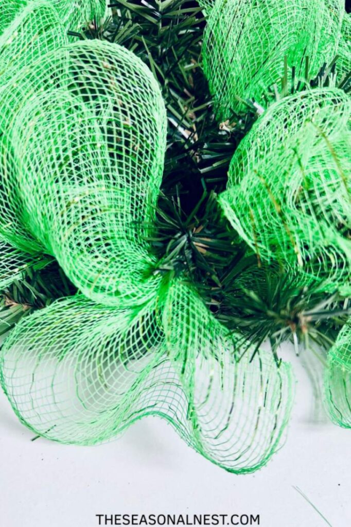 Two green mesh bundles on a wreath