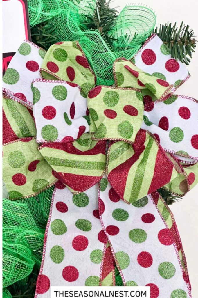 A Christmas bow on the side of the wreath