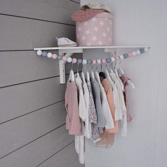 Cute corner baby clothes hanging rod