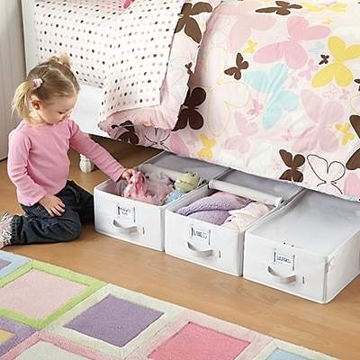 A girl taking a toy from under the bed container