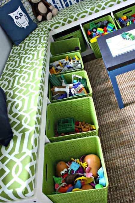 Storage baskets with toys underneath a long bench