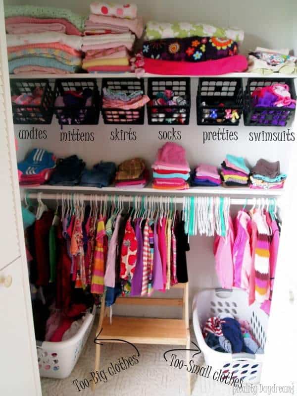 Perfectly organized baby closet with clothes on baskets and hangers