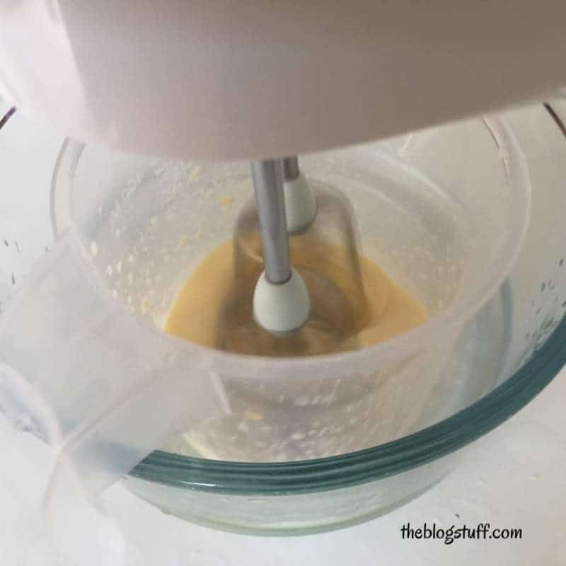 Mixing cream ingredients with hand mixer