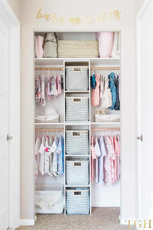 Vertical baby closet with baskets and clothes on hangers