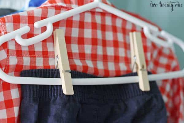 Organize baby clothes in closet with hangers and pegs