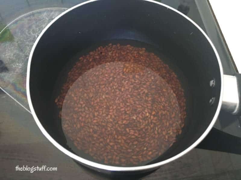 Flaxseeds covered with water in a pot 