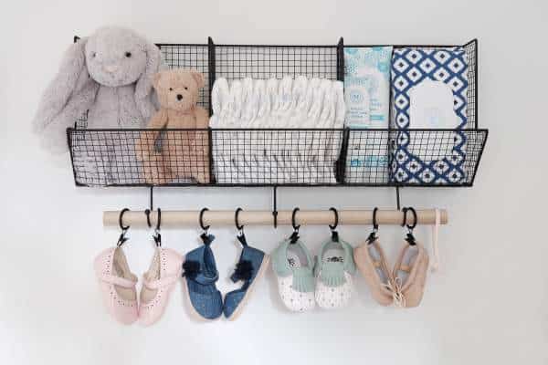 Baskets on a wall with organized baby items