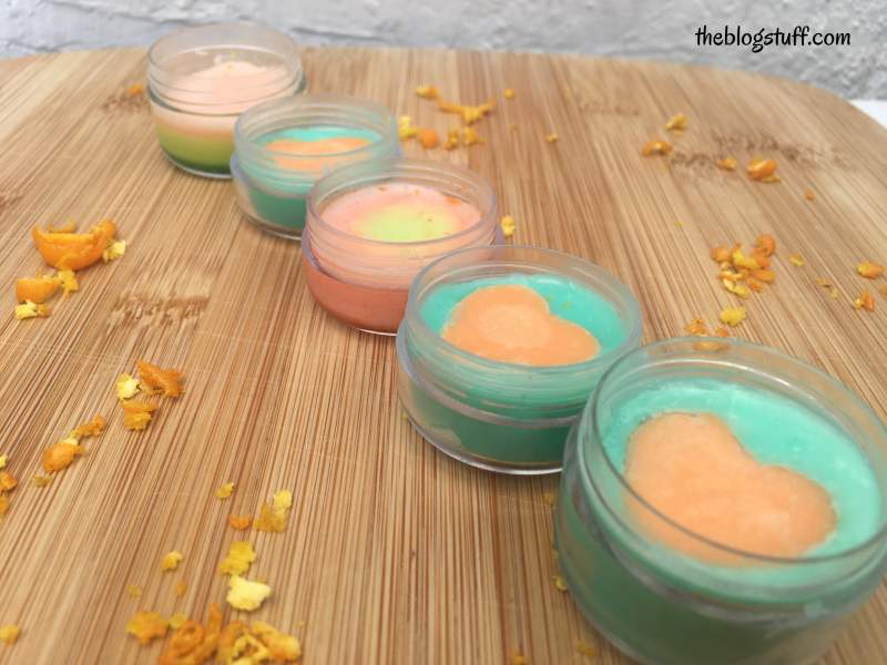 Homemade orange and mint lip balms in containers