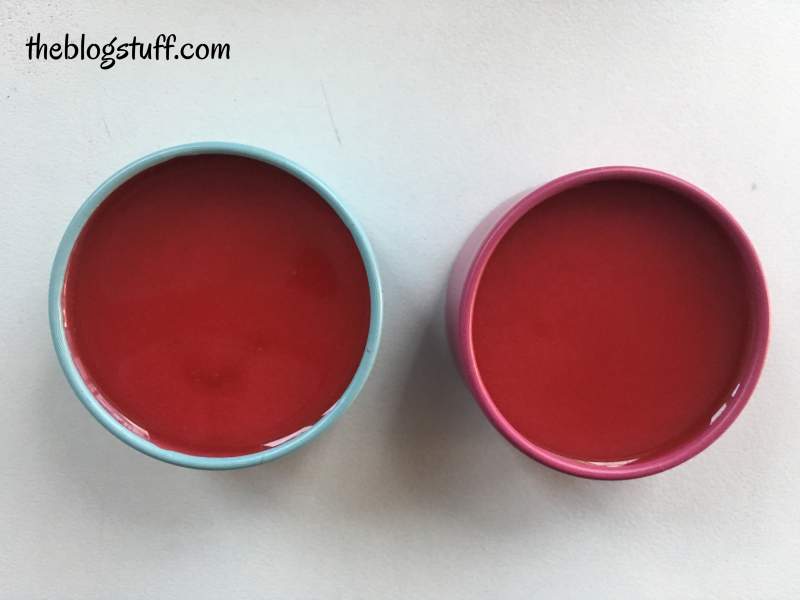 Red liquid lip balm in containers