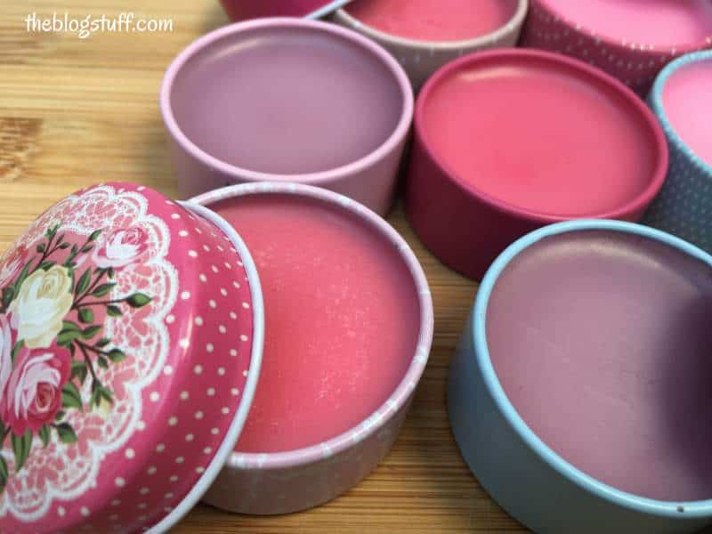 Tinted homemade lip balms in containers