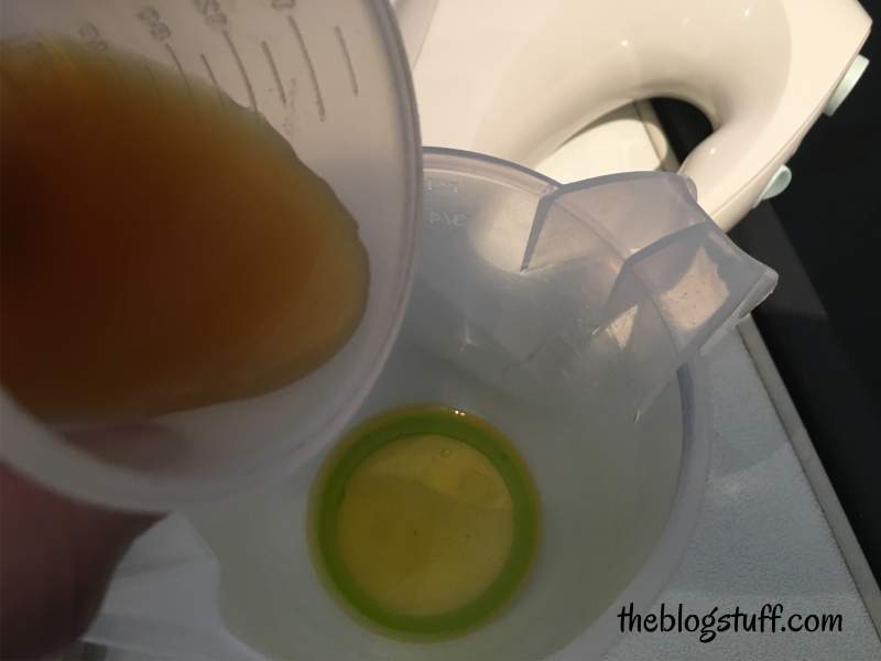 Pouring green tea into the Shea butter mixture