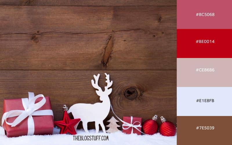 A simple and classic Christmas scene with red gift boxes tied with white ribbons, red ornaments, and a wooden reindeer cutout on a rustic wooden background. The combination of warm brown wood and festive red decorations gives the display a cozy, traditional holiday feel.