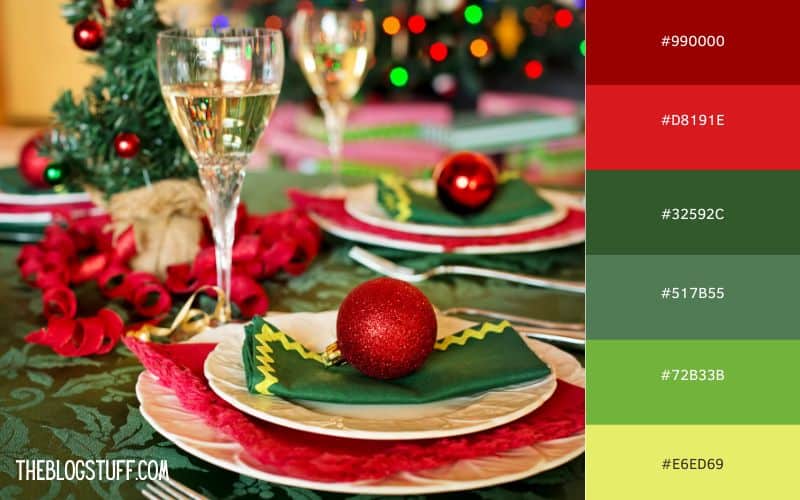 Festive Christmas dinner table with rich red and green tones, featuring a red ornament on green napkin. Classic holiday color palette of deep red, bright red, and various greens.
