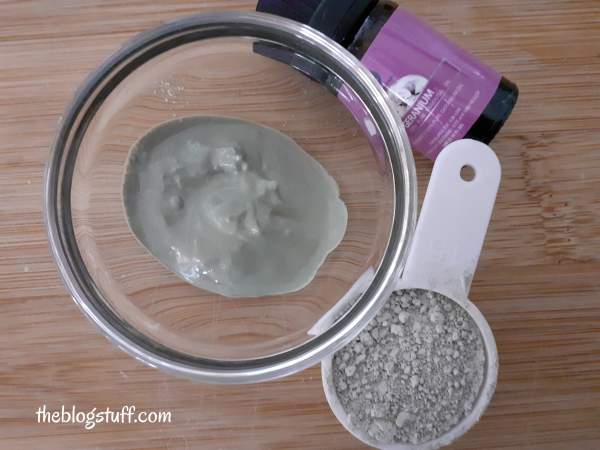 Green clay face mask in a container