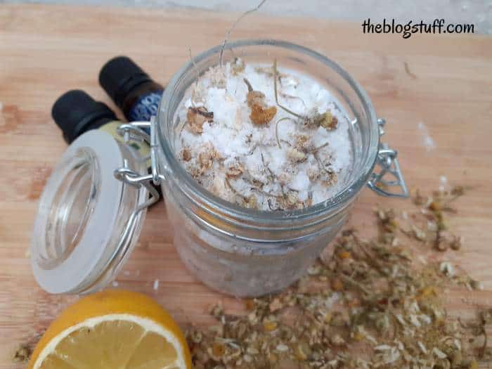 Homemade bath salts with essential oils in an open Mason jar