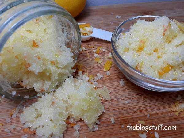 Homemade lemon sugar scrub with essential oil and lemon peel