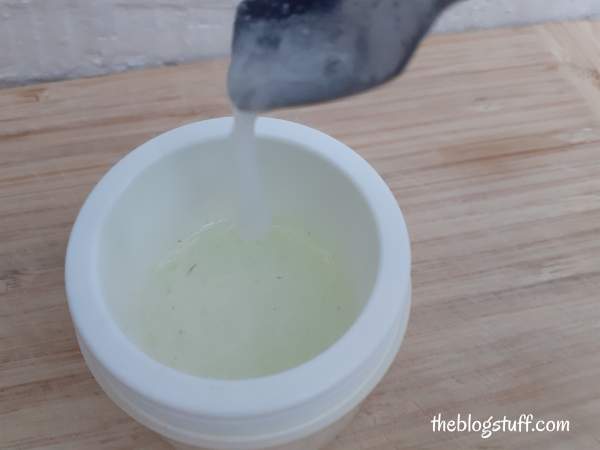 Pouring vitamin C mask into a container