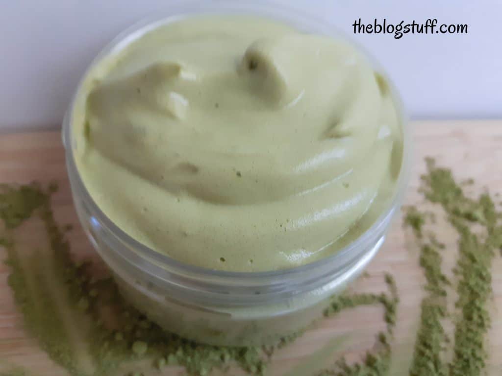 Homemade matcha face mask in an open jar