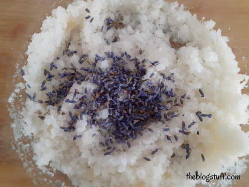 Adding essential oil and lavender buds to the mixture