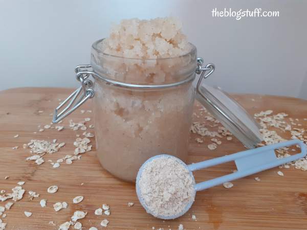 Homemade oatmeal body scrub with a spoon full of oats