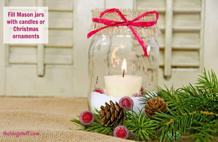 Mason jar decorated with candle, berries and greenery