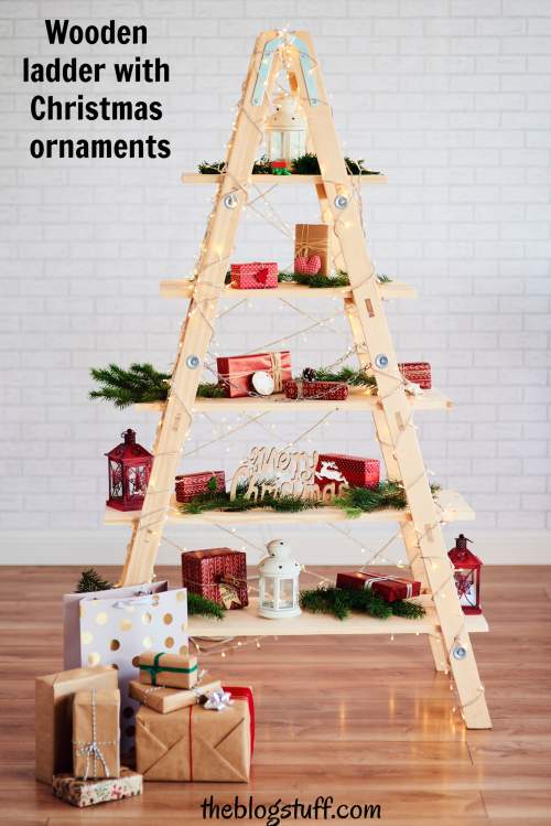 Wooden ladder with Christmas ornaments and gifts