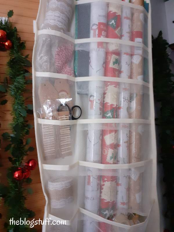 Using an over the door pocket organizer to store wrapping gift supplies