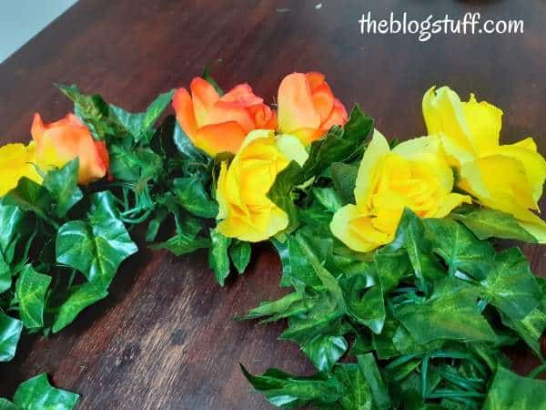 Securing the flowers to the back of the wreath with a wire