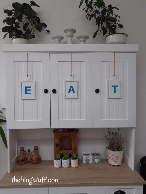 3 wooden cutting boards with the words EAT