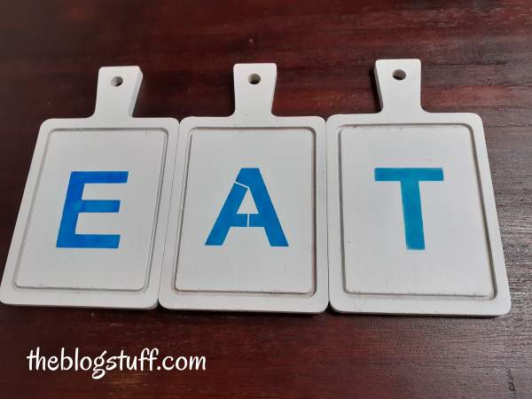 3 wooden cutting boards with the words "EAT"