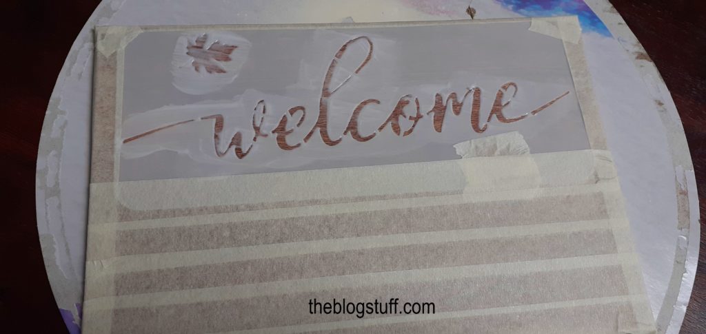 Making a wooden sign with the word welcome