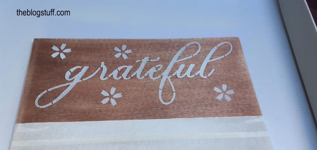 A piece of wood with the word "grateful"