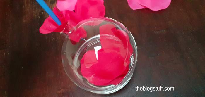 Filling a DIY Christmas bauble with faux rose petals