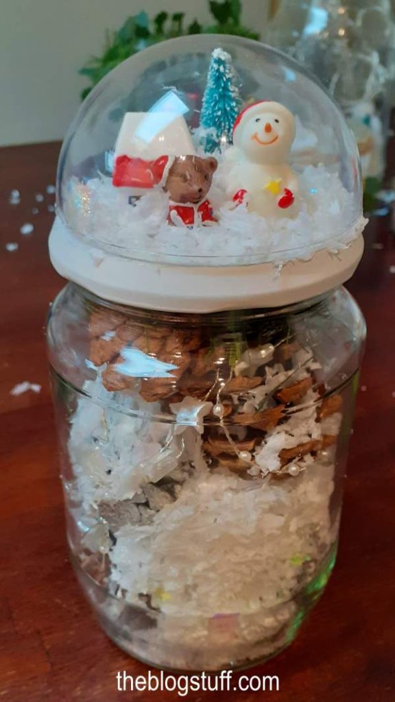 DIY Christmas Mason jar snow globe filled with pinecones