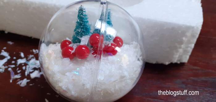 DIY Christmas bauble decorated with fake snow and trees