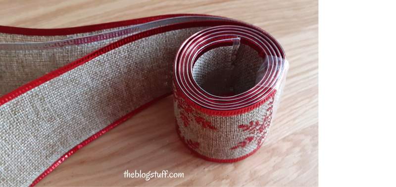 Christmas ribbon roll over wood