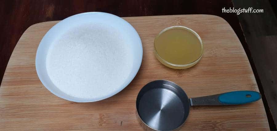 Sugar, lemon juice, and water on a wooden tray