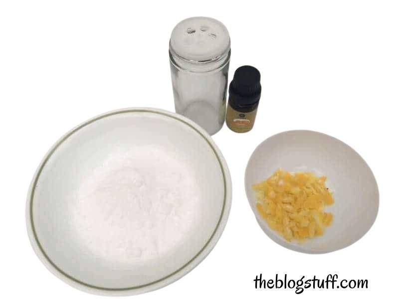 Baking soda, grated lemon peel, essential oil bottle, and container