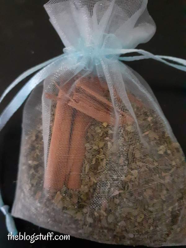 Dry herbs and cinnamon sticks inside an organza bag by The Blog Stuff