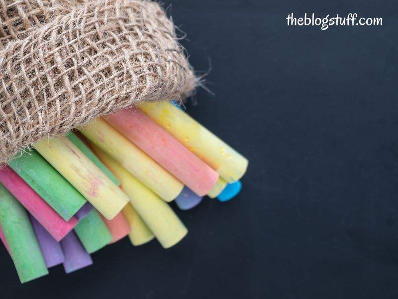 Color chalks in a bag with a black background