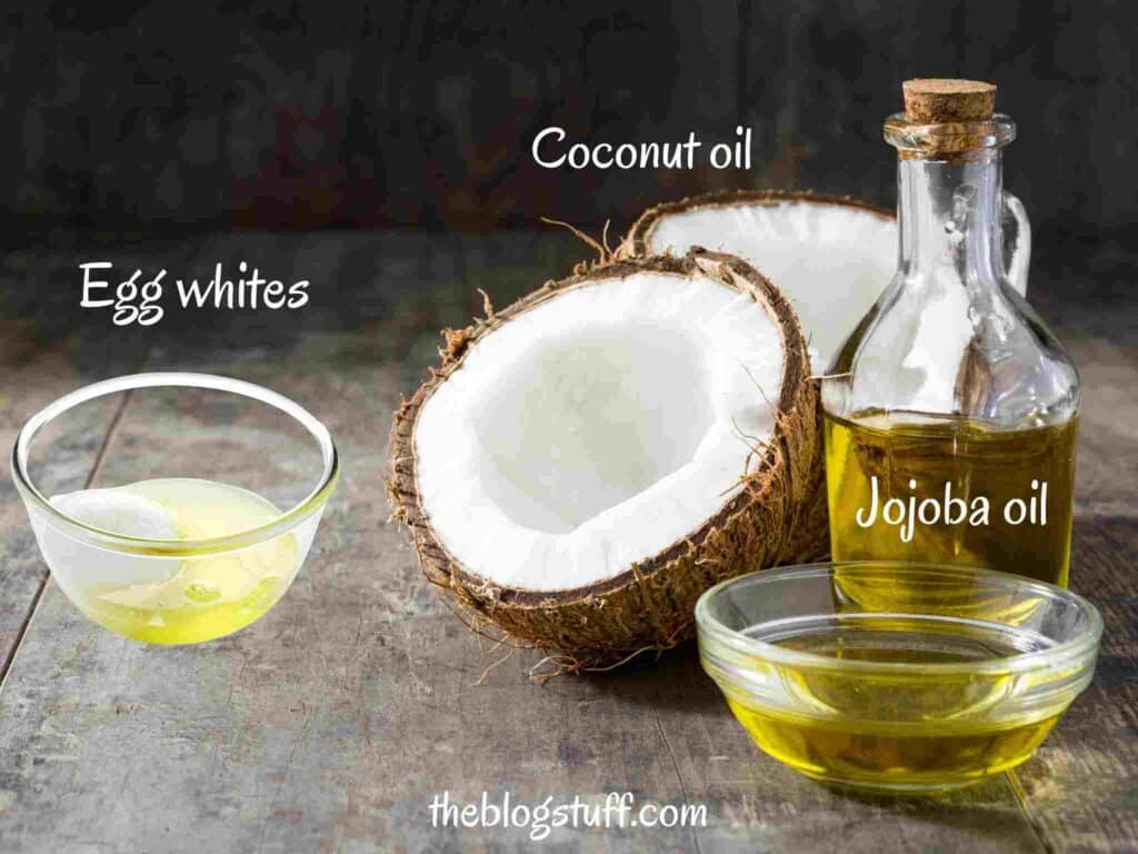 Egg whites, coconut oil, and jojoba oil on a wooden background