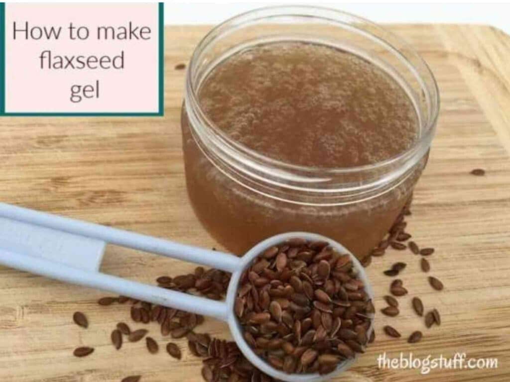 Homemade flaxseed gel in a container with a blue spoon with flaxseeds