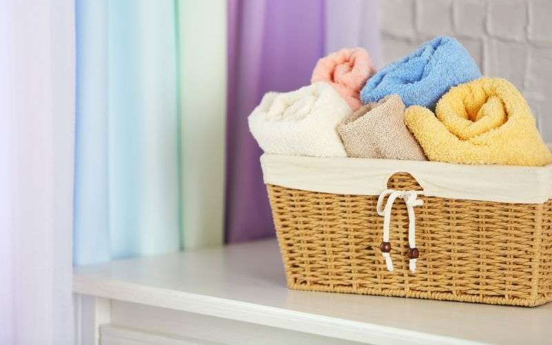 Wicker basket with rolled towels and washcloths