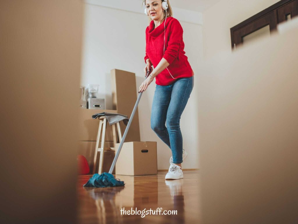 A woman listening to music and mopping the floor