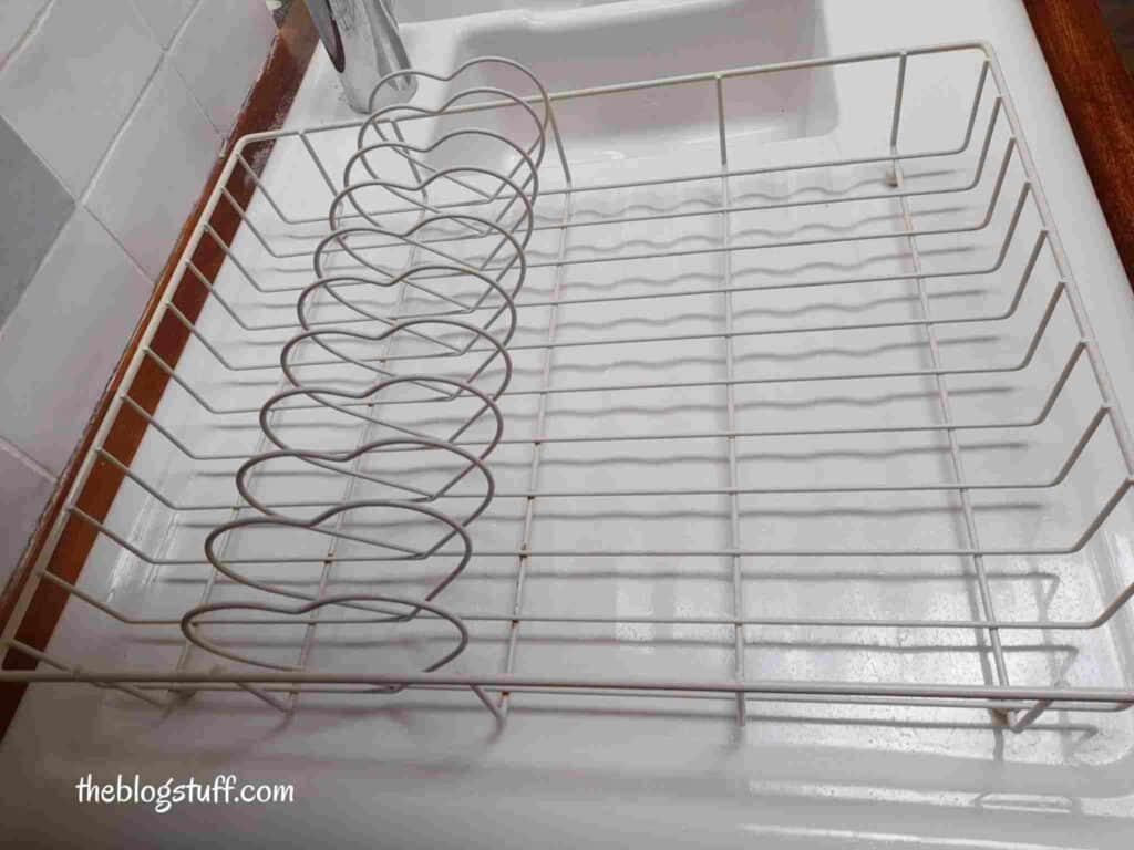 Cream kitchen sink dish drying rack