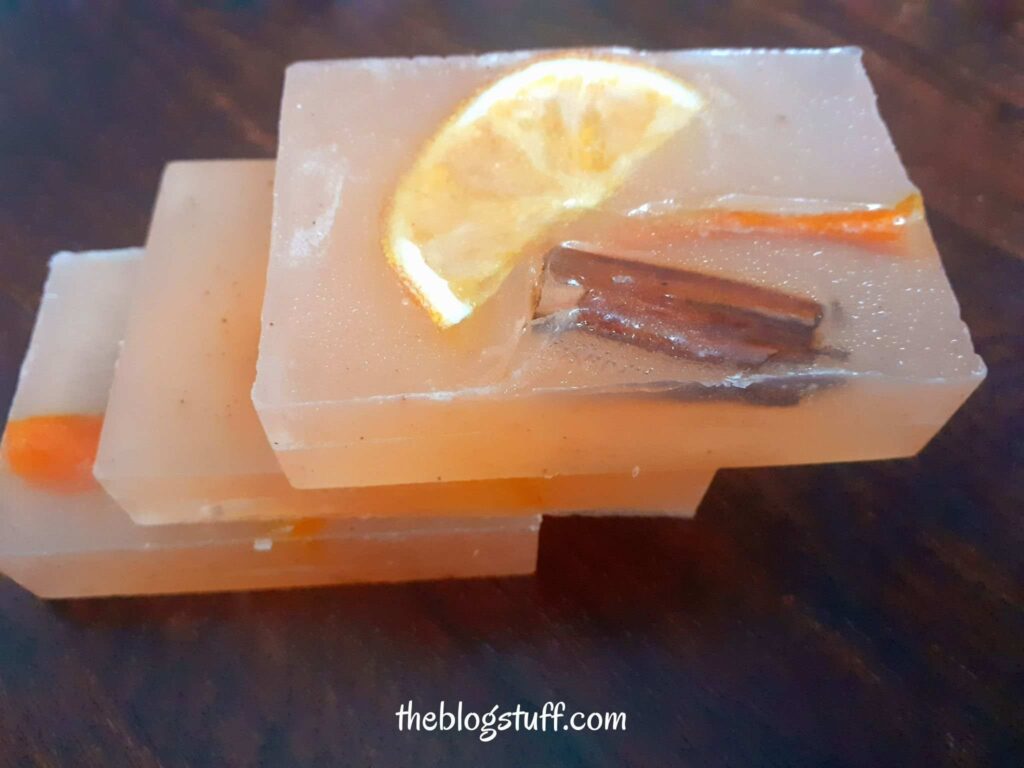 3 Citrus soap bars with orange slices and cinnamon sticks