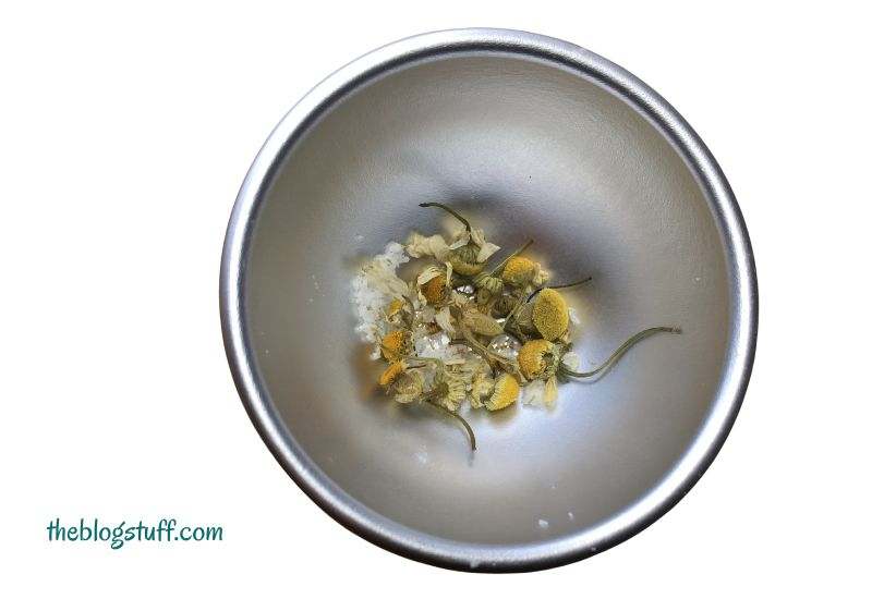 Dried chamomile flowers at the bottom of the mold