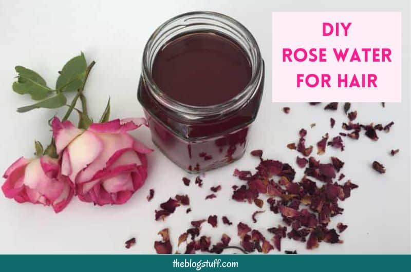 Homemade rose water in a glass jar and 2 pink roses