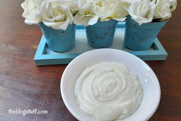 DIY hair mask in a bowl and 3 flower pots behind