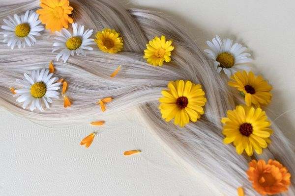 Blonde hair covered with pretty daisies